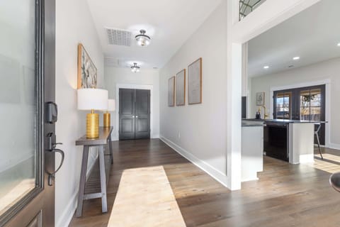 Step through this inviting hallway lined with warm details welcomes you inside. Follow it toward the living room and kitchen on the left.