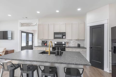This cozy, light-filled kitchen opens directly to the living room, with a sleek island ideal for morning coffee and quick bites.