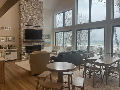 Spacious living room with soaring windows and cozy fireplace