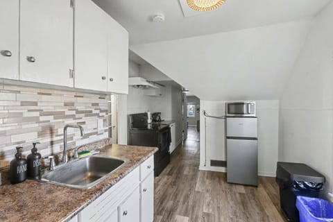 Step into a refreshed kitchen featuring a sleek tiled backsplash and full stove. This bright, streamlined space is fully equipped for your stay, offering the perfect spot to brew morning coffee or prep a home cooked meal.