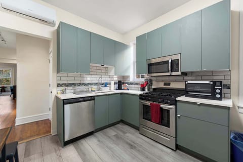 Streamlined kitchen layout w/ modern appliances & clean counters for stress-free cooking.