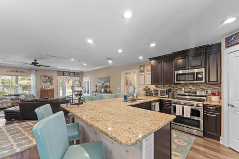 Fully stocked kitchen with stainless steel appliances.