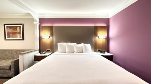 Drift off peacefully beneath warm lighting and cushioned headboard.