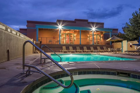 Slip into the warm spa as the pool glows softly.