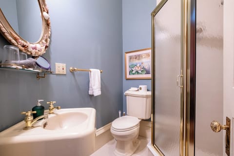 Private en-suite bathroom with walk-in shower, classic fixtures, and updated amenities.