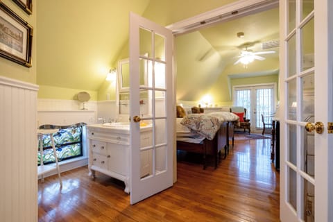 Bathroom-to-bedroom view highlighting the suite’s spacious layout and natural light flow.