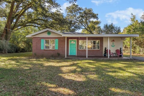 Welcome to a charming, single-story home set on a spacious lot with mature trees and plenty of privacy. The inviting front porch with seating creates a warm first impression and a perfect spot to enjoy the outdoors.