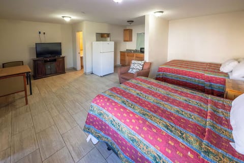 Spread out with two beds, TV, and kitchenette convenience.