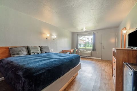 Unwind on the plush king bed in a bright room.