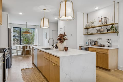 Kitchen: Sleek lines, warm tones, and high-end touches — the perfect kitchen for cooking, entertaining, and enjoying life together.