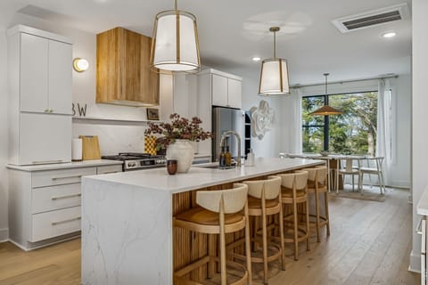 Kitchen: Sleek lines, warm tones, and high-end touches — the perfect kitchen for cooking, entertaining, and enjoying life together.