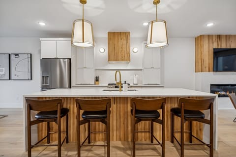 Kitchen: Sleek lines, warm tones, and high-end touches — the perfect kitchen for cooking, entertaining, and enjoying life together.