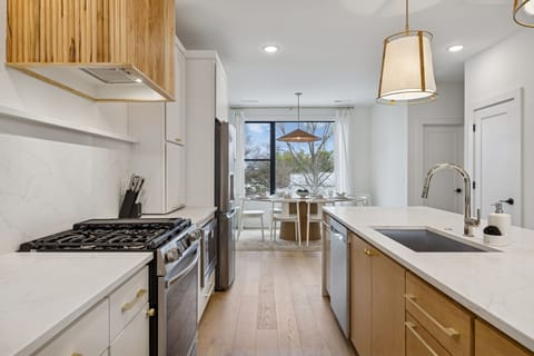 Kitchen: Sleek lines, warm tones, and high-end touches — the perfect kitchen for cooking, entertaining, and enjoying life together.