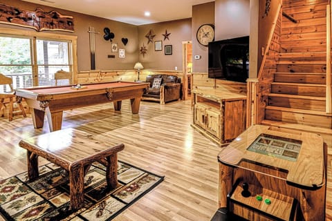 The game room offers a pool table, multi-cade arcade system and a large flat-screen TV, providing hours of entertainment for guests.