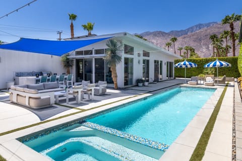 Soak up Palm Springs sun around the long saltwater pool and connected spa, framed by the house, private backyard and mountain views.