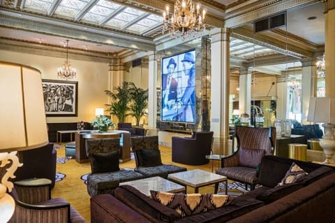 Experience the grandeur of our hotel lobby, complete with plush seating areas and exquisite artistic touches.