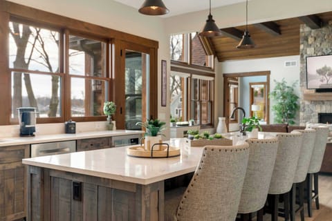 Our fully stocked gourmet kitchen is a showpiece, featuring designer cabinetry & a 12-foot quartz island with 6 barstools that face the lake.