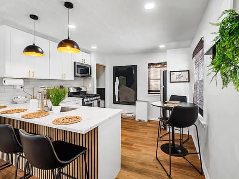 Dining space w/ island seating, stylish pendants & bright finishes