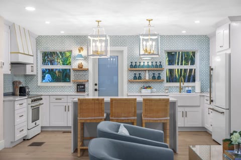 The heart of the home. This wide view shows the seamless connection between the kitchen and the stylish breakfast bar.