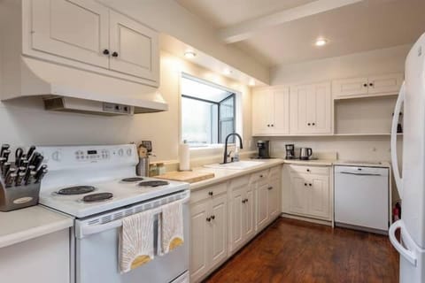 Clean, well-equipped kitchen with ample counter space and natural light—perfect for home-cooked meals, coffee rituals, and easy entertaining.