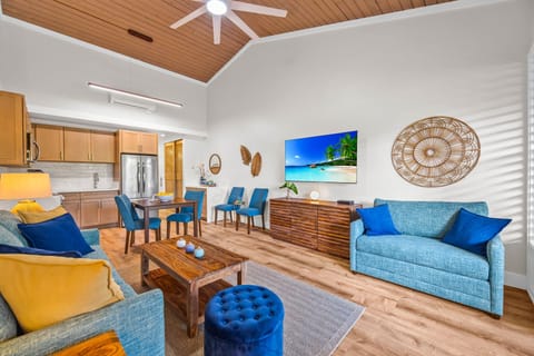 The heart of the home features soaring wood-paneled ceilings and an inviting open layout. Whether you're dining, lounging, or watching a movie, this space is designed for togetherness.