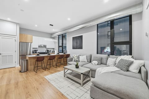 Open living area w/ comfy seating, clean lines & soft lighting for easy evenings in