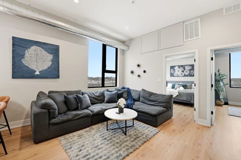 Open living area w/ comfy seating, clean lines & soft lighting for easy evenings in