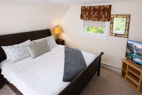 Cozy bedroom with fresh linens and smart TV—perfect for relaxing