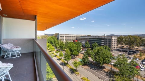 Sunny private balcony overlooking leafy streets and the neighbourhood below