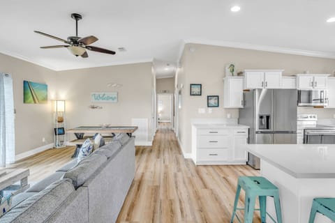 Spacious open-concept layout combining living and dining areas, featuring tropical décor and unobstructed canal views in Marathon, FL.