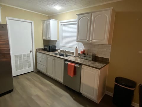 Dishwasher, large refrigerator, cook top stove with oven, pots/pans