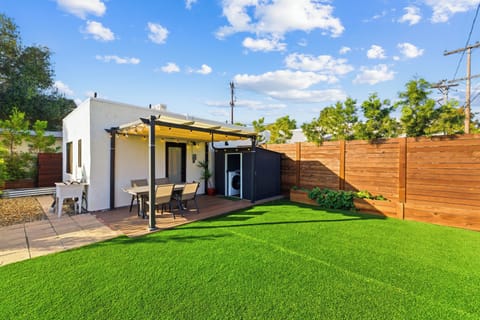 Large green backyard with seating and plenty of space for your and your pets to enjoy. Outdoor dining, fresh air and convenience of an outdoor washer & dryer.