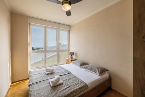 Comfortable bedroom with a queen-size bed, wardrobe and bedside table.
