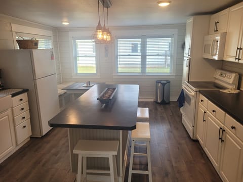 KITCHEN:  Overview of the kitchen, which has all appliances except for a dishwasher.  Also has a good supply of cooking and dining utensils.