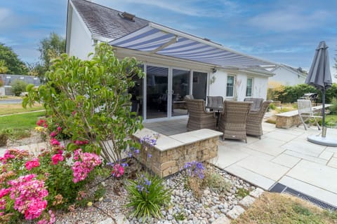 Brittas Bay Holiday Park No. 7. Exterior with patio, manicured garden, wicker furniture plus awning.