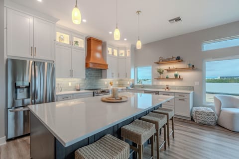 Your gourmet kitchen awaits with marble counters, custom cabinetry, and stunning water views for memorable meal prep.