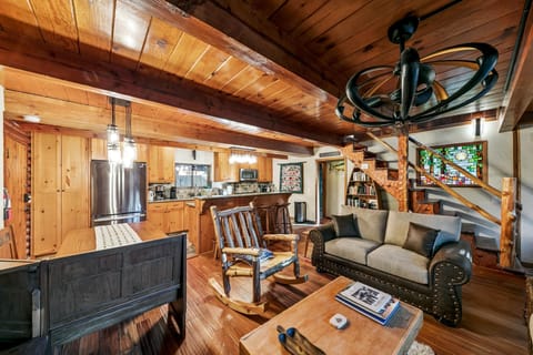 Cozy rustic living room with warm wood accents and loft access