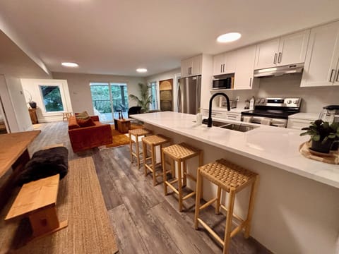 Bar seating near full kitchen. 