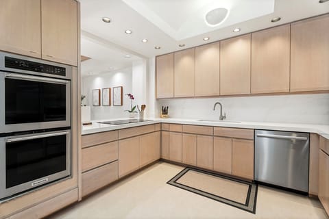 Fully equipped kitchen with induction stove, new appliances, and Calacatta quartz countertops