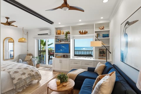 Living + Sleeping Area - Bright, modern studio with a brand-new king bed and ocean views just steps away.