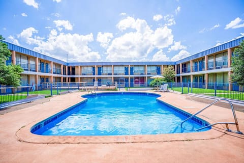Dive into sunlit relaxation with a sparkling central pool.
