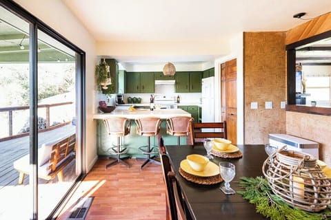 Open concept kitchen and dining area lead to the porch with additional seating.