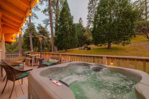 Private hot tub surrounded by tall pines, perfect for relaxing after a day exploring Yosemite.