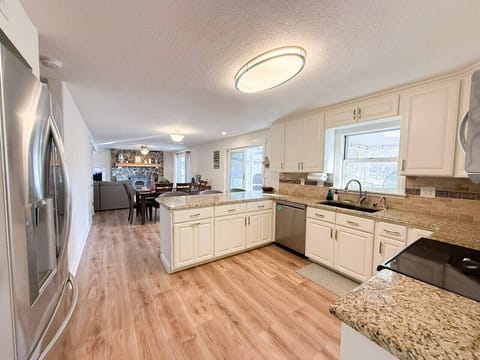 Cook, gather, and unwind in this bright open-concept kitchen with granite countertops and modern appliances, perfect for group stays.