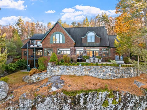 Stunning lakefront estate with private dock and panoramic views of Alton Bay