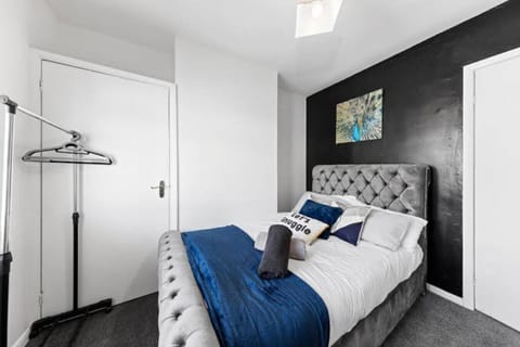 Bright double bedroom with elegant decor and soft throws