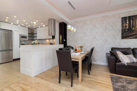 A stylish living room with a sofa and a dining table, perfect for meals and social gatherings