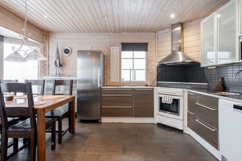 The kitchen is equipped with modern appliances and stylish dark surfaces