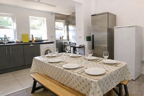 Gather at the kitchen table with place settings ready for a meal.