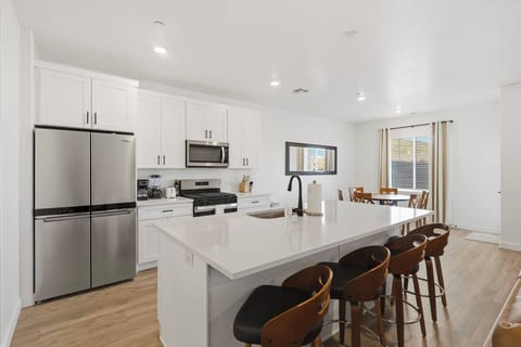 Fully equipped modern kitchen with large island and bar seating.